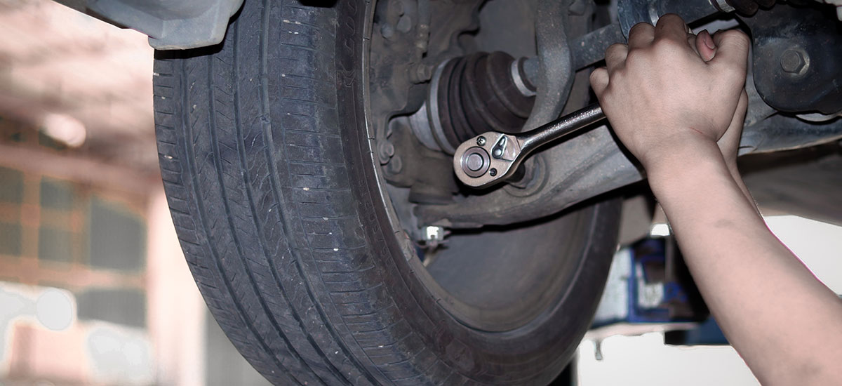 Suspension system and axle being serviced at repair shop